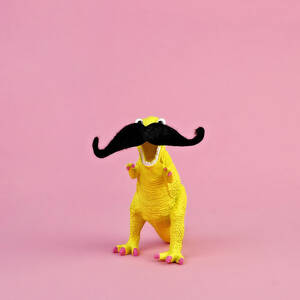 Toy Dinosaur With Mustache by Juj Winn