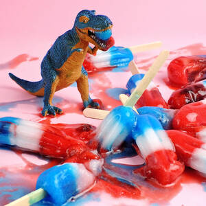 Toy Dinosaur With Red White And Blue by Juj Winn