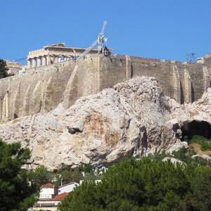 Greek Flag and Tourists on the Hilltop at Acropolis Crowded with Construction Crane in Athens Greece by John Shiron