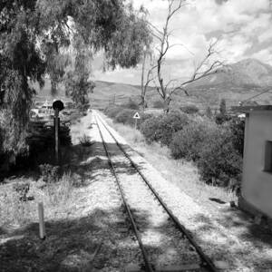 Railroad Crossing in Black and White on the Way from Mycenae to Olympia in Greece by John Shiron