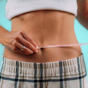 Woman Measuring Her Waist #1 by Bettina Salomon/science Photo Library