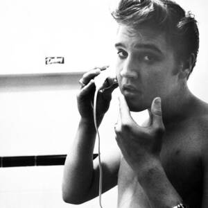 Portrait Of Elvis Presley Shaving by Globe Photos