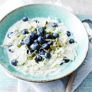 Still Life With Bowl Of Fresh Blueberries And Apple Oats by Brett Stevens