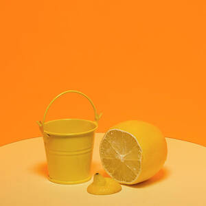 Abstract still life with a yellow bucket and a lemon by Valentin Ivantsov