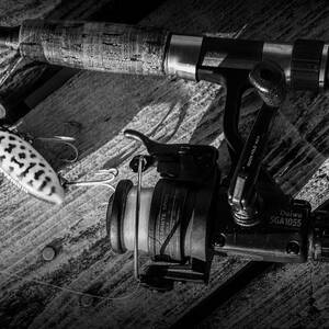 Fishing Rod with Spinning Reel and Jitterbug Crank Bait Photograph