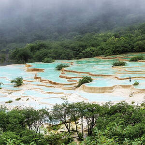 Panoramic View of Huanglong Terraced Pools in Misty Mountains by Benoit Bruchez