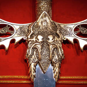 Sword Hilt and Guard Against a Red Background by John Twynam