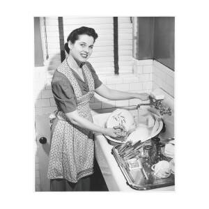 Woman Washing Dishes In Kitchen Sink by George Marks
