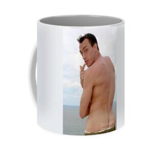 A playful sexy and hairy man poses on the beach at sunset. Coffee Mug by Gunther  Allen - Pixels